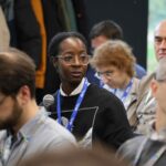 Person in the audience holding a microphone