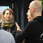 Three people talking to each other